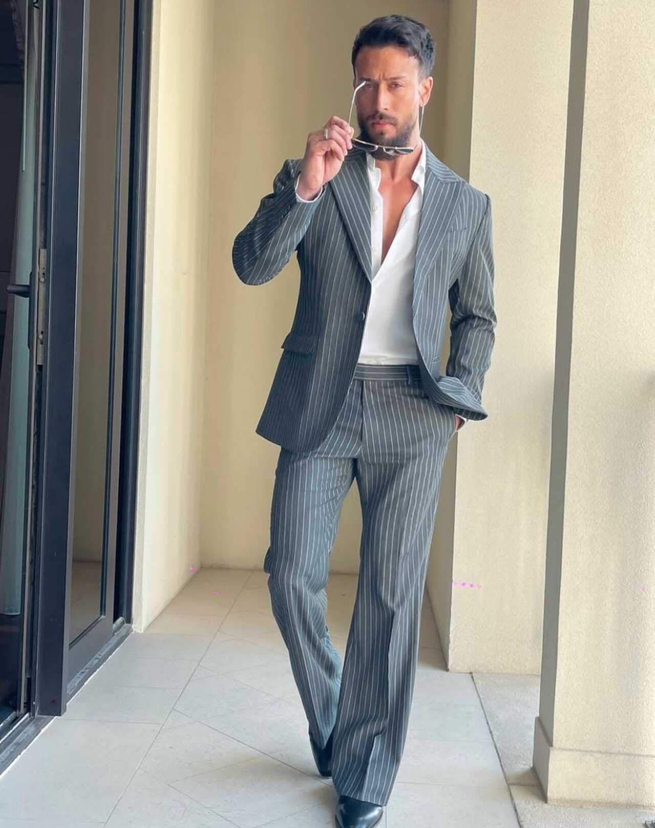 Tiger looks dapper in this grey pinstripe suit, which instantly adds authority and old-school charm. The vertical stripes elongate the frame and sharpen the silhouette.